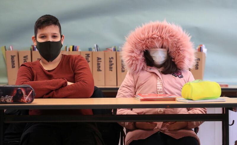 Schoolgirl of Freiherr-vom-Stein secondary school in the North Rhine-Westphalian city wears a winter outfit against the cold as school resumes with open windows and protective masks against the spread of COVID-19 following the autumn holidays in Bonn, Germany. REUTERS