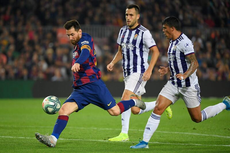 Barcelona's Argentine forward Lionel Messi shoots to score his second goal during the Spanish league football match between FC Barcelona and Real Valladolid FC at the Camp Nou stadium in Barcelona on October 29, 2019. / AFP / LLUIS GENE

