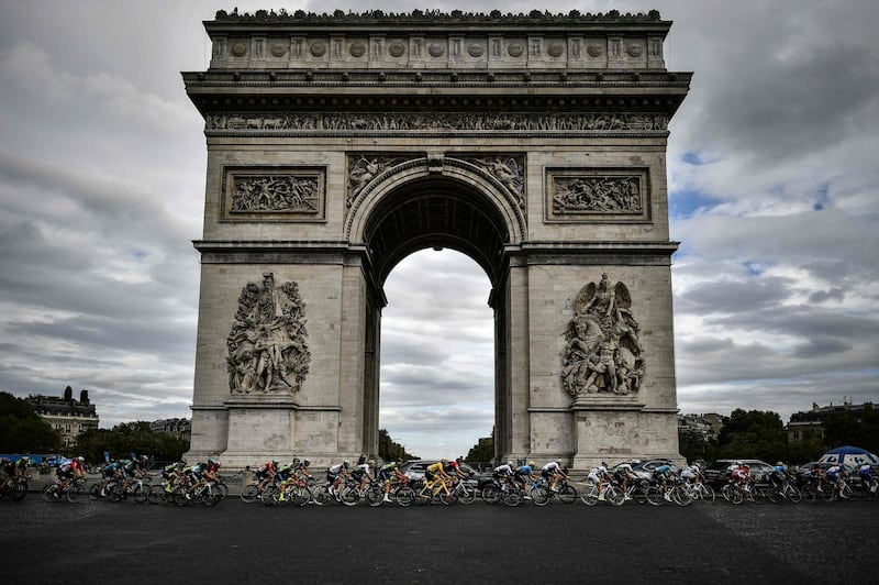 The pack rides past the Arc de triomphe monument. AFP