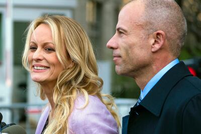 In this April 16, 2018 file photo, adult film actress Stormy Daniels, whose given name is Stephanie Clifford, and her attorney Michael Avenatti talk to reporters outside federal court in New York City.  Daniels has used an online crowdfunding site to raise hundreds of thousands of dollars in her legal case against President Donald Trump. But the unusual method of online fundraising for legal fees raises transparency questions about who is actually supporting her case. Daniels and her attorney, Michael Avenatti, have raised more than $490,000 on the website CrowdJustice.com.  (AP Photo/Craig Ruttle, File)