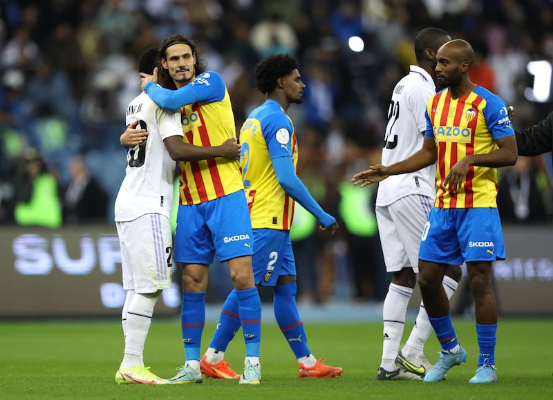 Vinicius Junior of Real Madrid and Edinson Cavani of Valencia embrace after the match. Getty