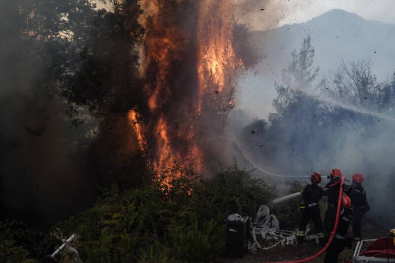 Firefighters from France extinguish a blaze that approached Neochori village in the Peloponnese, Greece, on August 12. Getty