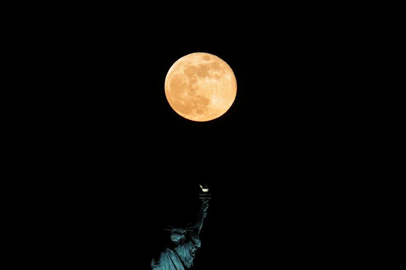 The full Moon rises above the Statue of Liberty, as seen from Jersey City, New Jersey, USA. Reuters