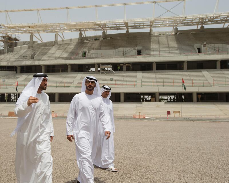 AL AIN, EASTERN REGION OF ABU DHABI, UNITED ARAB EMIRATES - May 08, 2013: HH General Sheikh Mohamed bin Zayed Al Nahyan Crown Prince of Abu Dhabi Deputy Supreme Commander of the UAE Armed Forces (2nd L), inspects the construction of the Hazza Bin Zayed Stadium, which will serve as the new home ground of Al Ain Football Club. Seen with HE Mohamed Mubarak Al Mazrouei Under-Secretary of the Crown Prince Court of Abu Dhabi (L), and HE Khalid Abdullah bin Shaiban Al Mehairi Director General of the Executive Council (back R). .( Ryan Carter / Crown Prince Court - Abu Dhabi ).---