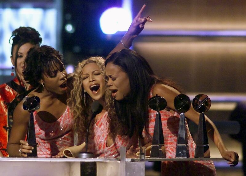 Destiny's Child, from left, Kelly Rowland, Beyonce Knowles and Michelle Williams sing as they accept the Artist of the Year Award at the 2000 Billboard Music Awards December 5, 2000 at the MGM Grand in Las Vegas. Reuters