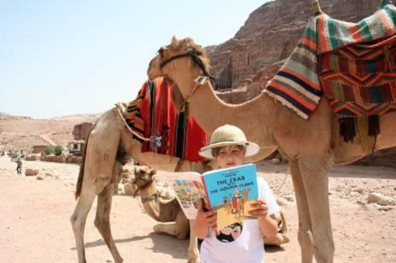 Benjamin Morris reading a Tintin adventure in Petra Jordan. Courtesy Johnny Morris