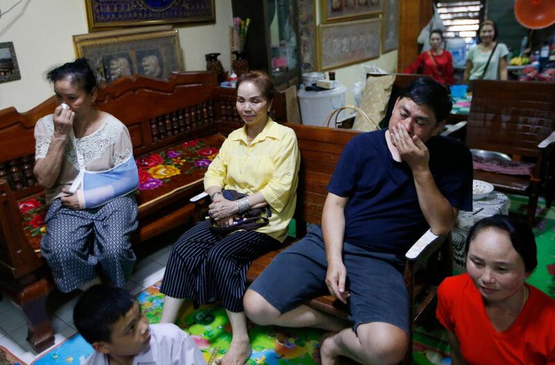 Family members watch the boys' press conference on television. AP Photo