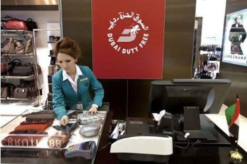Dubai, December 5, 2010 - A sales clerk arranges women's purses in a display at one of the Duty Free stores in Dubai's Airport Terminal 3, December 5, 2010. (Jeff Topping/The National)