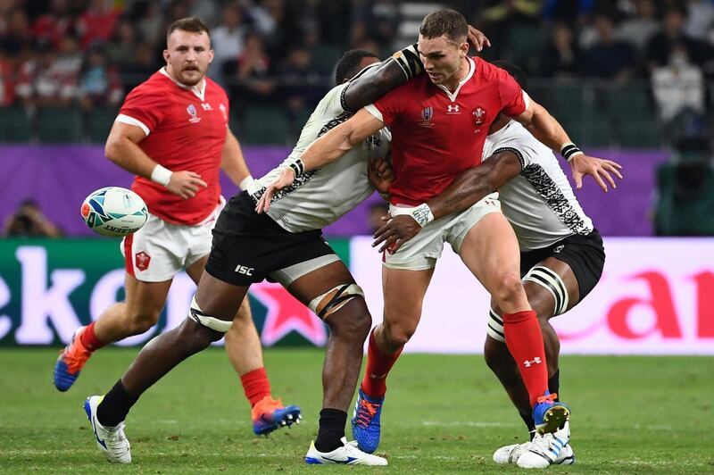 Wales' wing George North (2nd R) is tackled during the Japan 2019 Rugby World Cup Pool D match between Wales and Fiji at the Oita Stadium in Oita. AFP