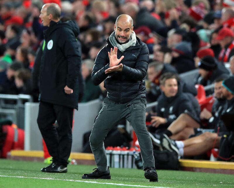 Manchester City manager Pep Guardiola instructs his players during the match against Liverpool at Anfield. PA