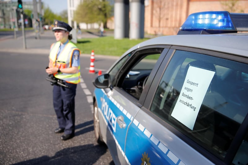 A police officer blocks a road next to the central train station in Berlin while a Second World War bomb is defused on April 20, 2018. Axel Schmidt / Reuters