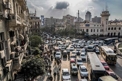 This picture taken on February 22, 2021 shows a view of vehicles stuck in a traffic jam in the central Attaba district of Egypt's capital Cairo. In gridlocked and heavily polluted Cairo, startups are searching for technological solutions to solve the transport headaches for an expanding megacity already struggling with over 20 million people. Cairo, the most populous Arab city where a fifth of all Egyptians live, is ranked 30th worst in the world for congestion, according TomTom, the Dutch vehicle navigations systems maker. / AFP / Khaled DESOUKI
