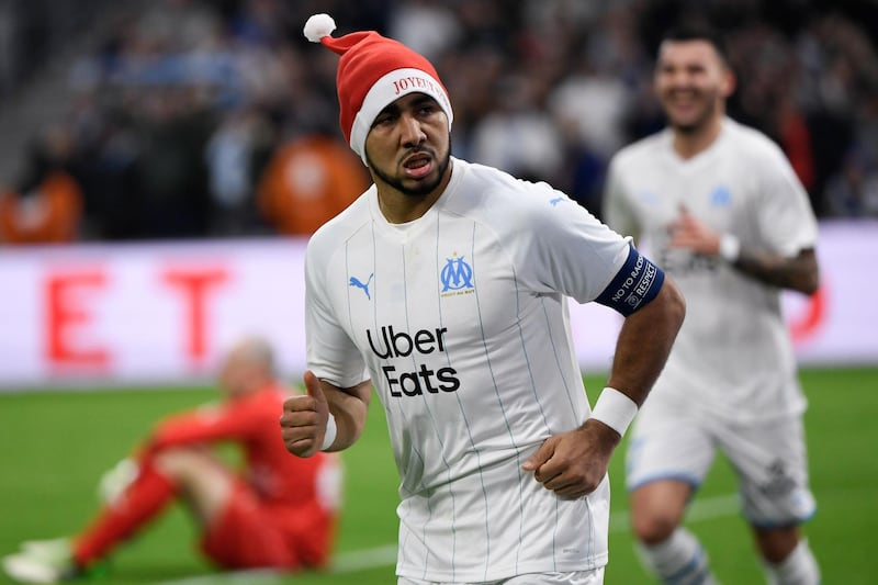 Marseille's French midfielder Dimitri Payet decided to get into the festive spirit by sporting this Santa Claus hat after scoring for Marseille against Nimes in December, 2019. AFP