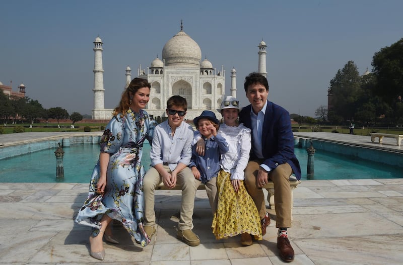 Prime Minister of Canada Justin Trudeau, his wife Sophie Gregoire and their children pose for a photograph during their visit to Taj Mahal in Agra on February 18, 2018. - Trudeau and his family arrived at the Taj Mahal on February 18, kickstarting their week-long trip to India aimed at boosting economic ties between the two countries. (Photo by MONEY SHARMA / AFP)