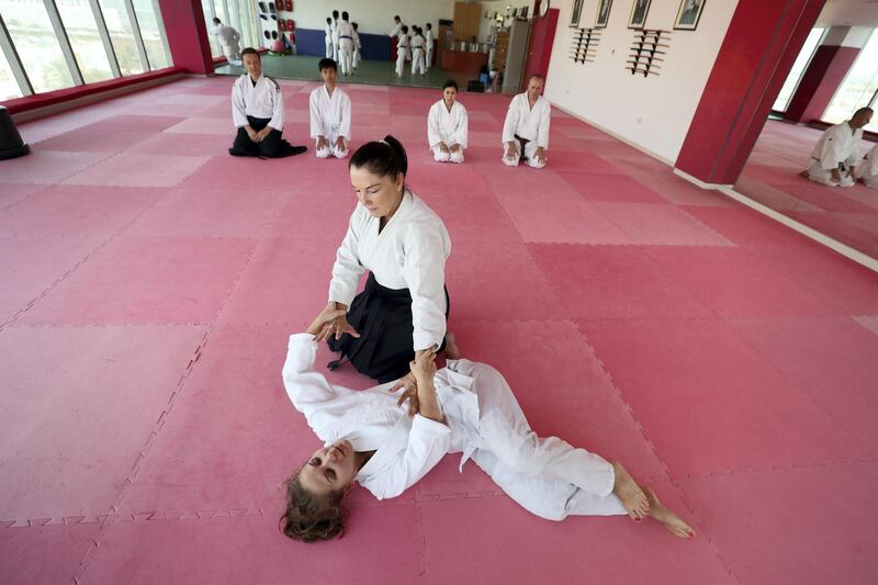 Dubai, United Arab Emirates - July 20, 2019: Cathy Darnell with Anna Monastirskaya. Cathy Darnell is the only female Aikido instructor in Dubai and is a 4th dan, she has the oldest dojo in the country, Zanshinkan Aikido club Dubai is celebrating our 25th anniversary in 2020. Saturday the 20th of July 2019. Al Barsha, Dubai. Chris Whiteoak / The National