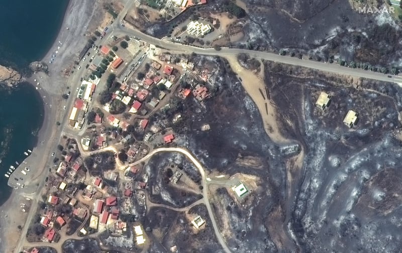 Burned-out buildings in Kiotari, after about 20,000 people fled from homes and hotels on the island. AP