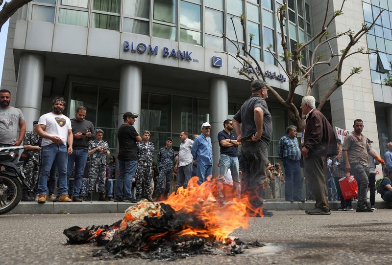 Demonstrators at a protest organised by the Depositors' Outcry campaigning group in front of Blom Bank in Beirut. Reuters