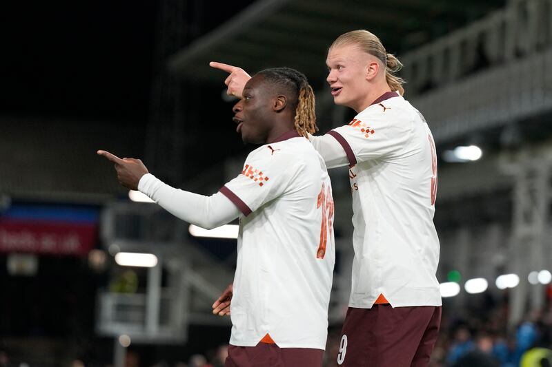 Manchester City's Erling Haaland, right, celebrates with his teammate Jeremy Doku after scoring his side's third goal. AP