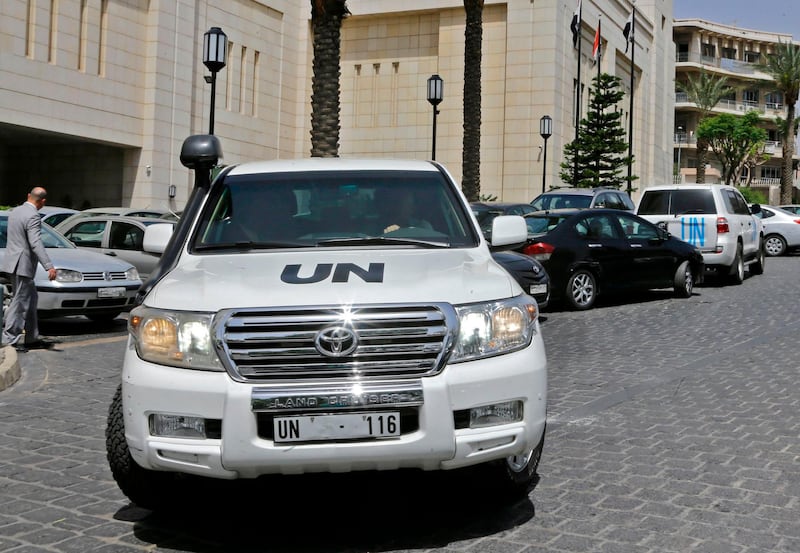 United Nations vehicles are seen outside the hotel where the international experts from the Organisation for the Prohibition of Chemical Weapons (OPCW) are staying in Damascus on April 19, 2018. 
UN security experts have said they were negotiating with Syrian and Russian authorities for international chemical inspectors to deploy to the site of an alleged toxic gas attack near Damascus, after a reconnaissance mission came under fire. The team from the world's chemical arms watchdog has not yet been able to begin its field work in Douma, where dozens were killed in a suspected April 7 gas attack, as Western powers warn that President Bashar al-Assad's regime may attempt to remove crucial evidence.
 / AFP PHOTO / LOUAI BESHARA