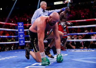 Tyson Fury is knocked down by Deontay Wilder in the fourth round.  AP Photo