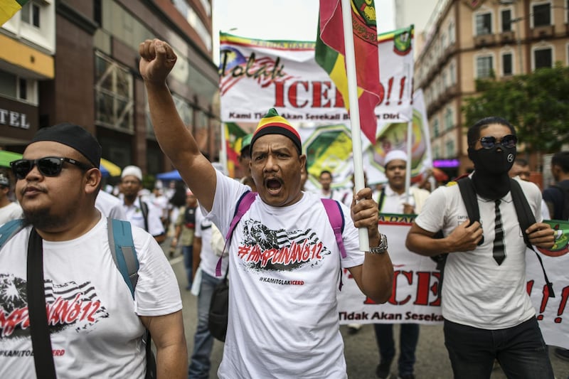 A protester (C) shouts slogans during a rally organised by Muslim politicians against the signing of the UN anti-discrimination convention (ICERD) at Merdeka Square in Kuala Lumpur. AFP