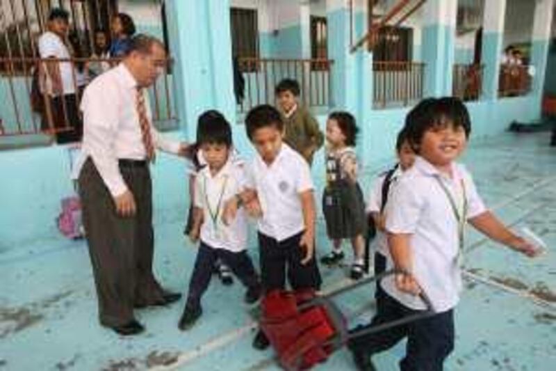 ABU DHABI 19th April 2010. VILLA SCHOOLS BEING CLOSED DOWN. Daniel Sistona, School Principle at the Pioneers International Private School in Abu Dhabi, with some of his pupils  at the end of lessons yesterday (monday)      Stephen  Lock   /  The National   