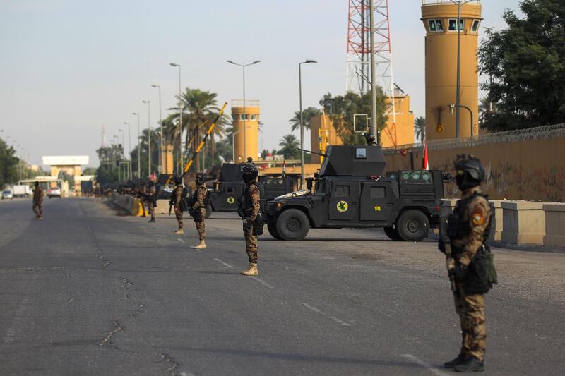 (FILES) In this file photo taken on January 02, 2020 Iraqi counter-terrorism forces stand guard in front of the US embassy in the capital Baghdad after hundreds of men stormed the high-security Green Zone and besieged the US compound. As Iraqi Prime Mininister Mustafa al-Kadhemi prepares for his first meeting with US President Donald Trump this week, attacks on American targets by pro-Iranian fighters have been on the rise. With Tehran and Washington competing for influence in Iraq, the gulf between pro-Iranian factions and the US-friendly premier Kadhemi is growing.
 / AFP / AHMAD AL-RUBAYE
