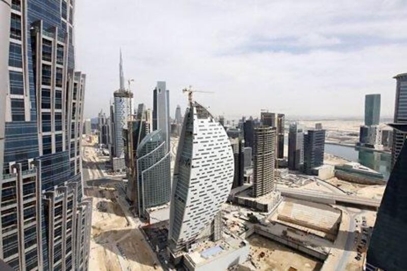 Iris Bay, the sail-shaped building, in Dubai's Business Bay area by the Indian developer Sheth Estate, remains incomplete after work stopped more than a year ago. Jeffrey E Biteng / The National