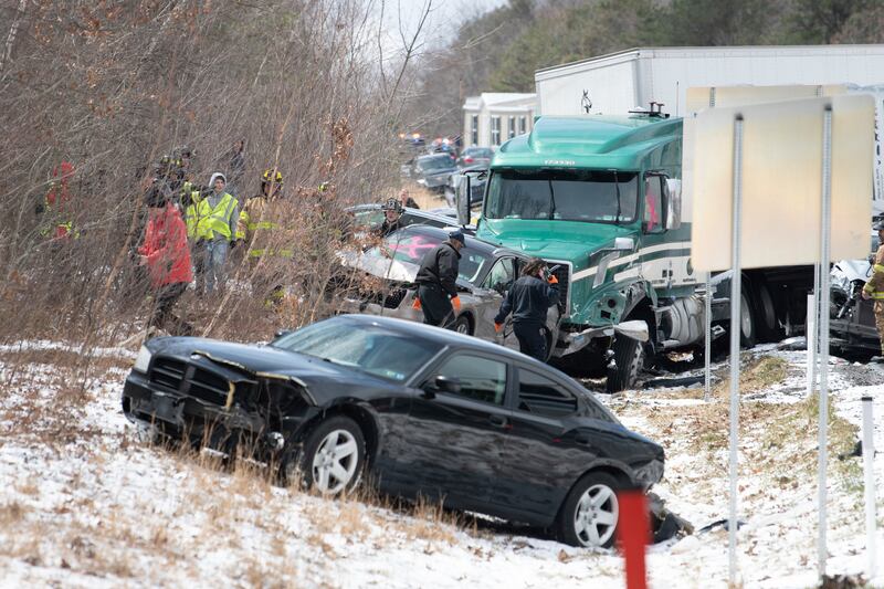Emergency personnel work at the scene of the crash on the Interstate 81 motorway. Republican-Herald / AP