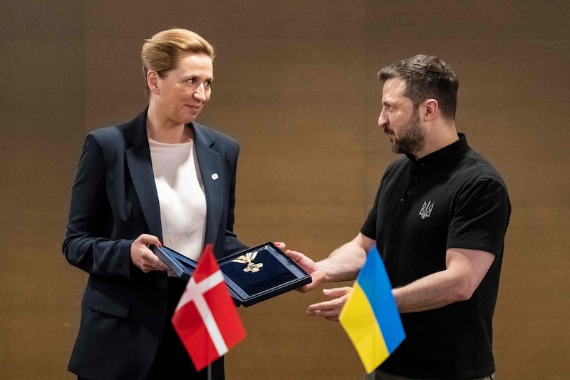 Mr Zelenskyy awards Denmark's Prime minister Mette Frederiksen with the 'Order of Freedom of Ukraine' title before a meeting on the sidelines of the summit. AFP