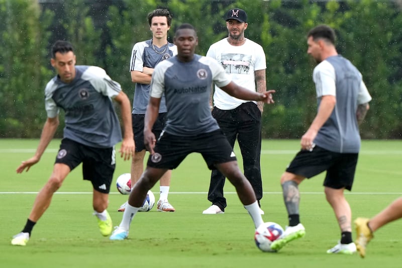 Inter Miami co-owner David Beckham, rear right, watches with his son Cruz, rear left, as midfielder Sergio Busquets, left, and forward Lionel Messi, right, do drills during practice. AP Photo 