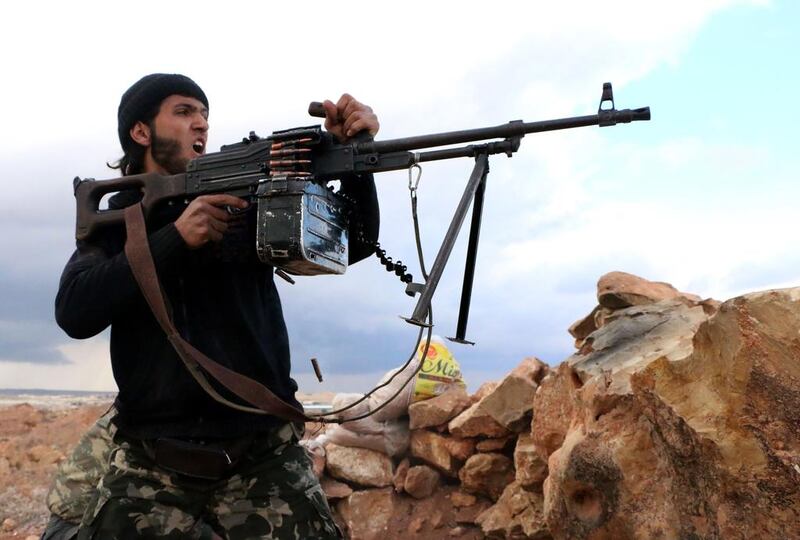 A rebel fighter fires towards pro-regime forces during clashes in Sheikh Najar area of Aleppo. The Assad regime has sought to pit rebel groups against each other, in order to emerge victorious. (AFP Photo/Aleppo Media Centre/Fadi Al Halabi.)