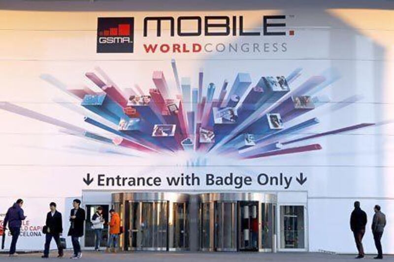 People are seen next to an entrance of the Mobile World Congress, in Barcelona. REUTERS / Albert Gea
