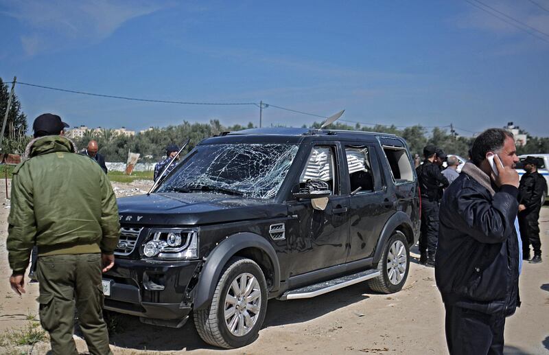 epaselect epa06600426 Hamas security officials inspect one of the cars of Palestinian Prime Minister Ramil Hamdallah's convoy that was targeted in an attack after his arrival in Beit Hanun town, the northern Gaza Strip, 13 March 2018. Prime Minister Rami Hamdallah on 13 March survived an assassination attempt after entering the Gaza Strip. The President’s Office condemned the attack and held Hamas, the de facto power in Gaza, responsible.  EPA/MOHAMMED SABER