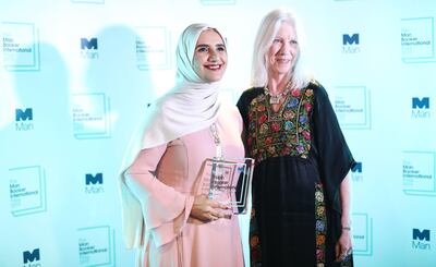 Arabic author Jokha Alharthi (L) and translator Marilyn Booth pose after winning the Man Booker International Prize for the book 'Celestial Bodies' in London on May 21, 2019.   / AFP / Isabel INFANTES

