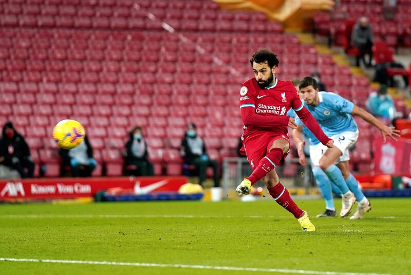 LIVERPOOL, ENGLAND - FEBRUARY 07: Mohamed Salah of Liverpool scores their side's first goal from the penalty spot during the Premier League match between Liverpool and Manchester City at Anfield on February 07, 2021 in Liverpool, England. Sporting stadiums around the UK remain under strict restrictions due to the Coronavirus Pandemic as Government social distancing laws prohibit fans inside venues resulting in games being played behind closed doors. (Photo by Tim Keeton - Pool/Getty Images)