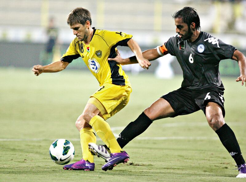 DUBAI, UNITED ARAB EMIRATES - October 10, 2012- Al Wasl's Emiliano Alfaro (L) keeps the ball away from AL Dhafra's  Ali Msarri Al Dhaheri ¨ during first half football action in Zabell Stadium in Dubai City, Dubai October 10, 2012. (Photo by Jeff Topping/The National)