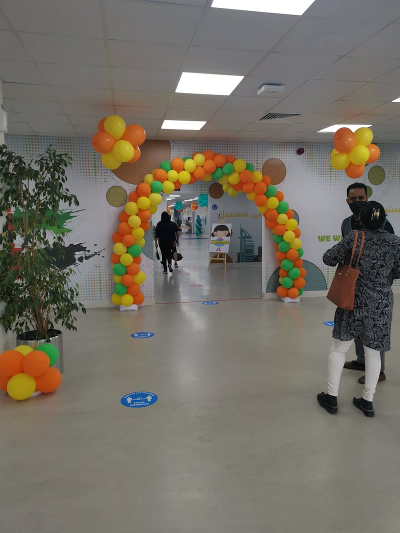 The centre is decorated with balloons and cartoon cutouts.