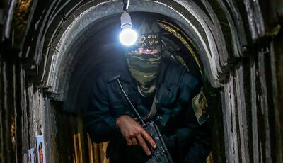 A Palestinian fighter of Al-Quds brigades, the military wing of Palestinian Islamic Jihad (PIJ), takes position in a military tunnel near the rally marking the first anniversary of the May 2021 conflict between Israel and Gaza, in Beit Hanun, northern Gaza Strip, 18 May 2022.   EPA / MOHAMMED SABER