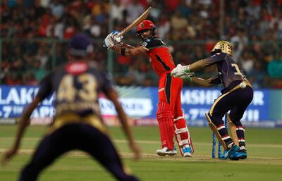 Royal Challengers Bangalore captain Virat Kohli, center, plays a shot during the VIVO IPL T20 cricket match between Royal Challengers Bangalore and Kolkata Knight Riders in Bangalore, India, Friday, April 5, 2019. (AP Photo/Aijaz Rahi)