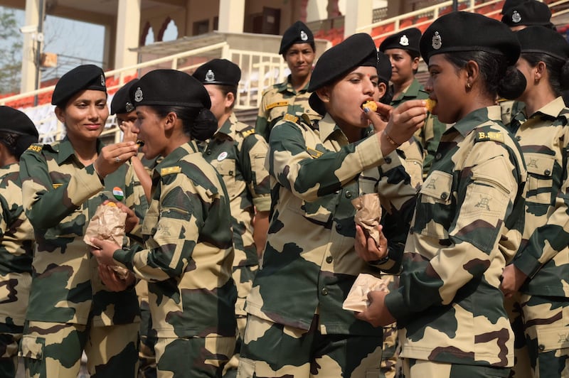 Indian Border Force staff offer sweets to each other on Independence Day at the India-Pakistan Wagah frontier post, 35km from Amritsar. AFP