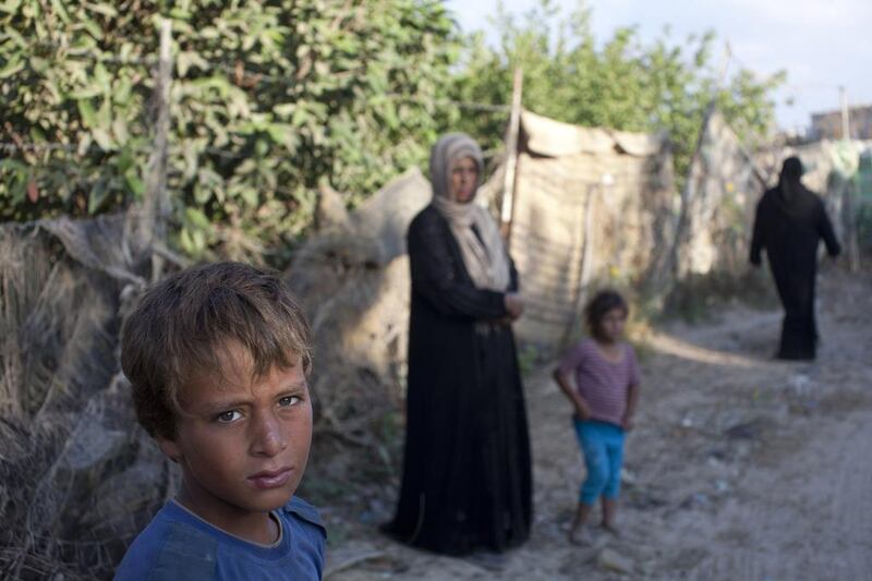 Only a handful of families live here in the makeshift tents and houses among the dried out olive trees just one kilometre from the heavily-fortified Israeli border. Those that do say that they are too poor to move closer to the city. Heidi Levine for The National