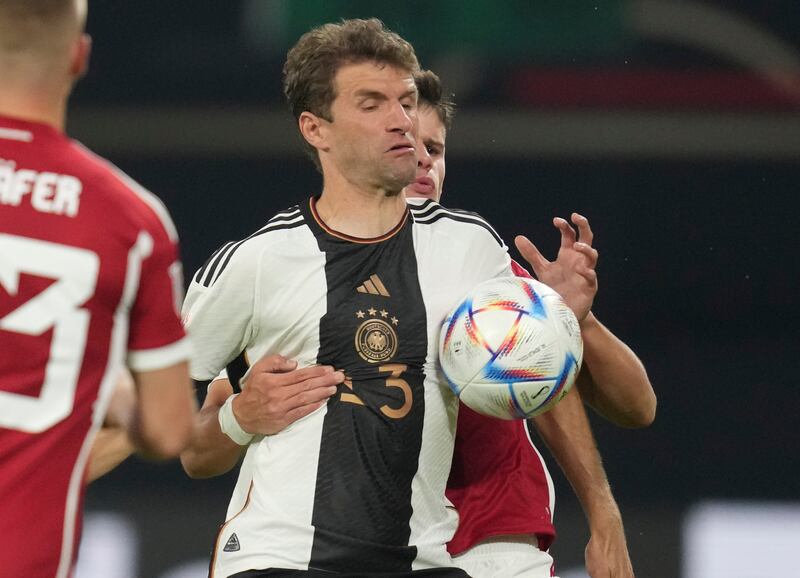 Hungary's Milos Kerkez, right, challenges for the ball with Germany's Thomas Muller. AP