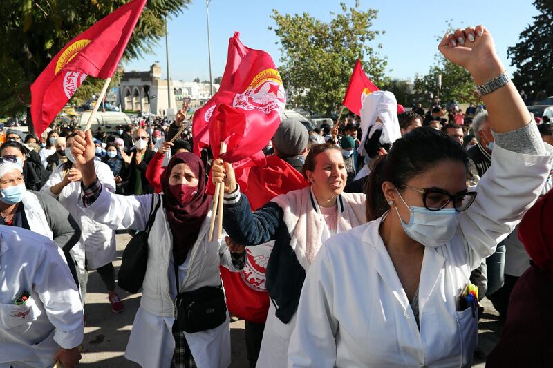 epa08998742 Tunisian health professionals take part in a demonstration demanding better working conditions in front of the Ministry of Health in Tunis, Tunisia, 09 February 2021. The General Health Federation has announced an open strike from 09 February in all health establishments in the country and the suspension of all medical benefits except in urgent cases.  EPA/MOHAMED MESSARA