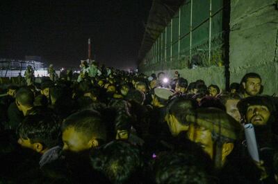 Afghans hoping to flee the country wait outside the part of Kabul airport controlled by foreign forces. Photo: AFP