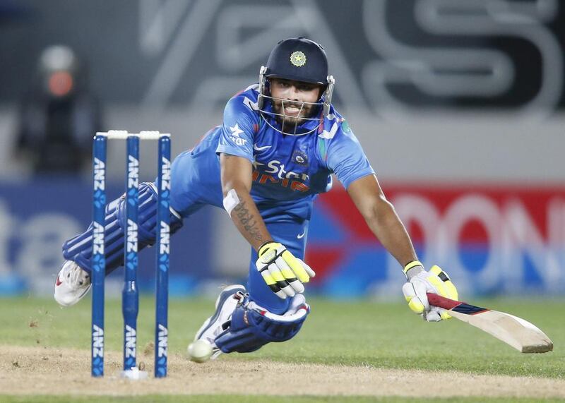 India's Ravindra Jajeda dives back to the crease as the ball misses the stumps on Saturday during the third one-day international against New Zealand. Nigel Marple / AFP

