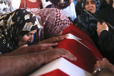 Relatives of Turkish diplomat Osman Kose cries on his coffin during his funeral ceremony in Ankara, Turkey, 18 July 2019. EPA