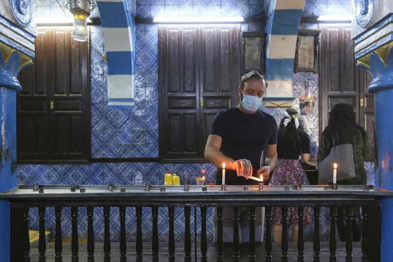 A Tunisian Jewish pilgrim lights a candle on the first day of the annual pilgrimage to the Ghriba Synagogue, the oldest Jewish monument built in Africa, in the Mediterranean Tunisian resort island of Djerba. AFP