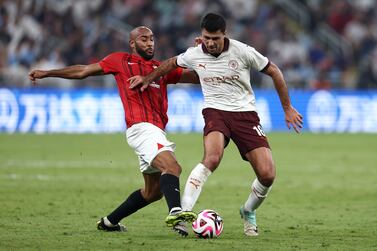 JEDDAH, SAUDI ARABIA - DECEMBER 19: Rodri of Manchester City is challenged by Jose Kante of Urawa Red  during the FIFA Club World Cup Saudi Arabia 2023 Semi-Final match between Urawa Reds and Manchester City at King Abdullah Sports City on December 19, 2023 in Jeddah, Saudi Arabia. (Photo by Francois Nel / Getty Images)