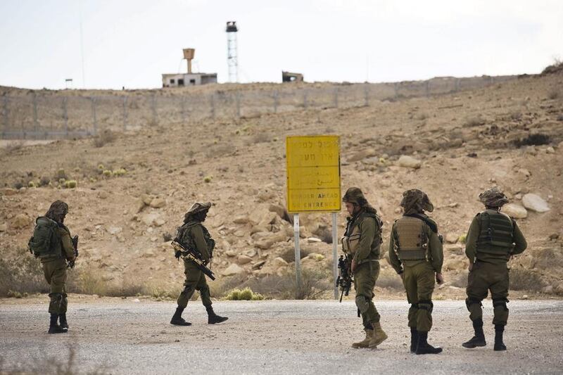 Israeli soldiers patrol the area near the Israeli-Egyptian border after coming under fire from extremists based in Sinai. In El Arish, around 30 Egyptian soldiers were killed in a suicide bombing. Photo: Amir Cohen / Reuters